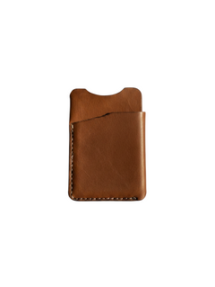 Hidden House Co. minimalist brown full-grain leather card holder with reinforced stitching and slim profile.