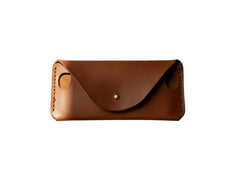 Hidden House Co. handcrafted brown leather glasses case with a minimalist envelope design and brass stud closure.