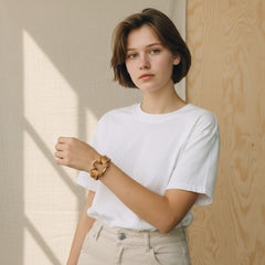 Woman wearing a Hidden House Co. tan vegetable-tanned leather bracelet with a solid brass ring on her wrist