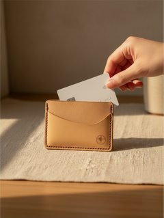 Hidden House Co. minimalist vegetable-tanned leather card holder with hand-stitched details and a white credit card.