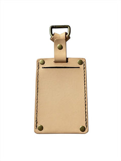 Hidden House Co. handcrafted light tan vegetable-tanned leather luggage tag with brass hardware and privacy cover.