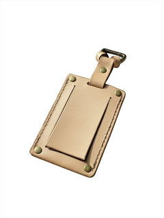 Hidden House Co. tan vegetable-tanned leather luggage tag with a privacy cover and brass hardware.