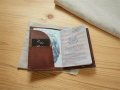 Hidden House Co. brown leather passport and notebook cover with interior card slot on a wooden surface