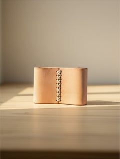 Hidden House Co. handcrafted vegetable-tanned leather scarf slide with rustic hand-stitched center detail