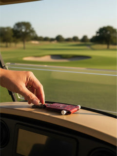 Hidden House Co. deep red handcrafted leather golf tee caddy and ball marker holder on a golf cart dashboard