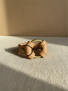 Hidden House Co. natural tan vegetable-tanned leather bracelet featuring a solid brass ring and brass hardware.